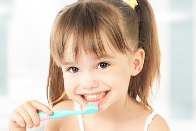 A little girl brushing her teeth
