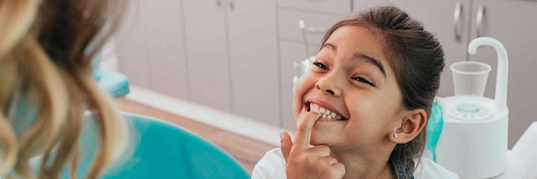 A child touching her teeth after dental check up in Pacifica CA