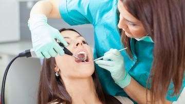 Woman receiving a dental cleaning | Dentist office Pacifica, CA