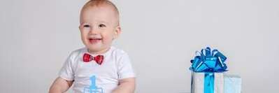 A baby with a gift box | pediatric dentist Pacifica, CA