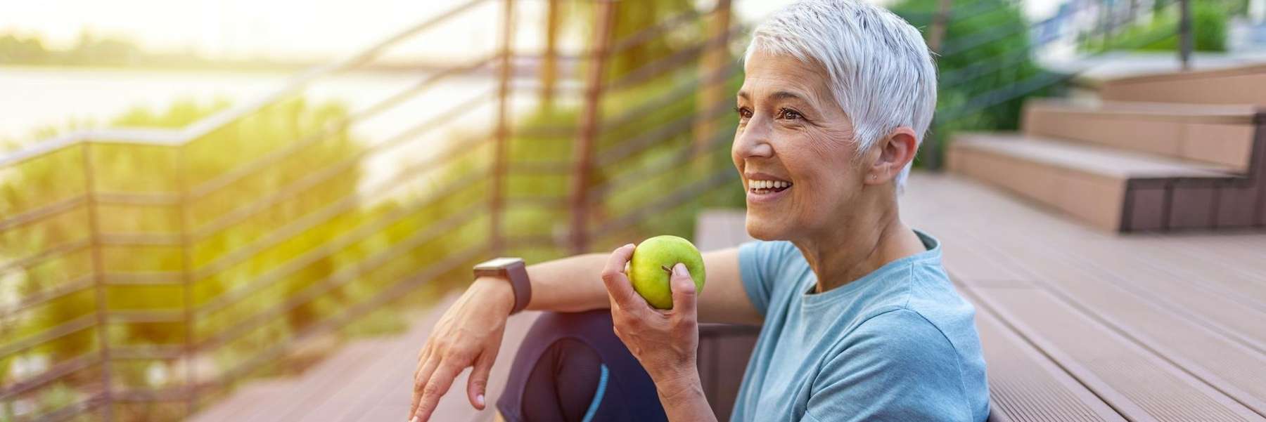 A woman eating an apple outside