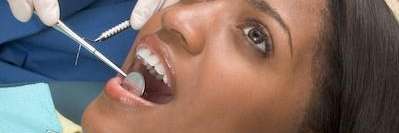 Woman receiving a dental exam | Dentist in Pacifica, CA