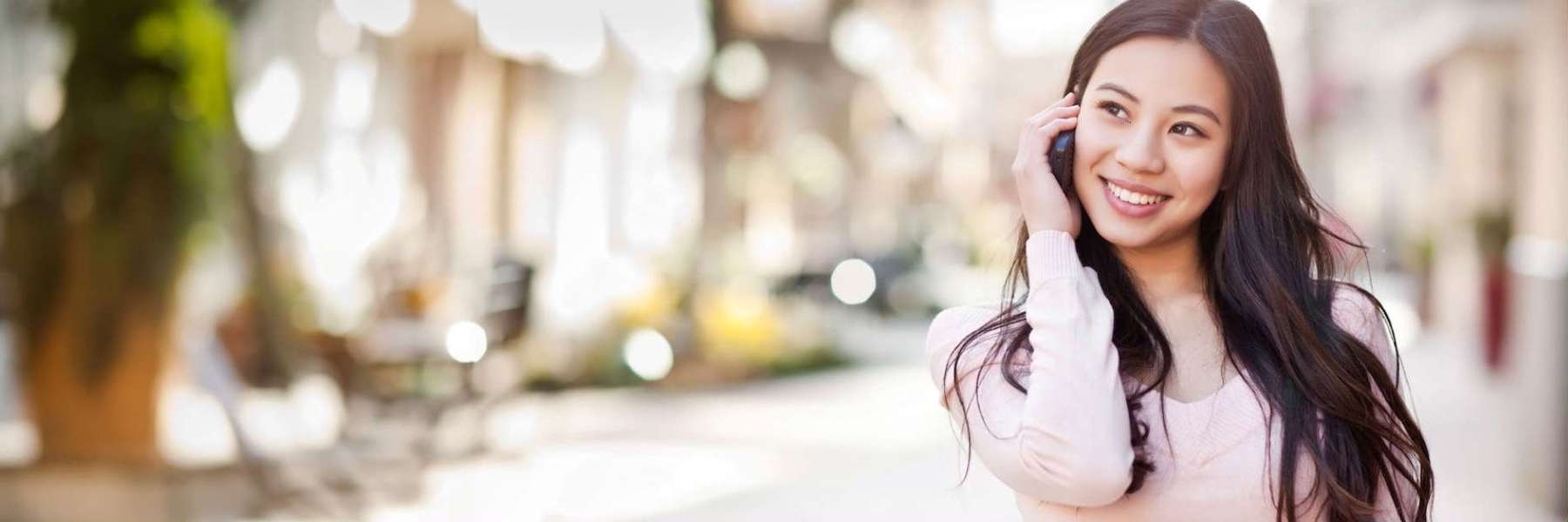 A woman on a call smiling after a Cosmetic Dentistry procedure in Pacifica, CA