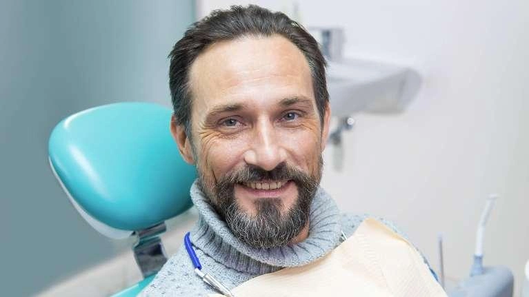 A patient smiling while visiting a dentist
