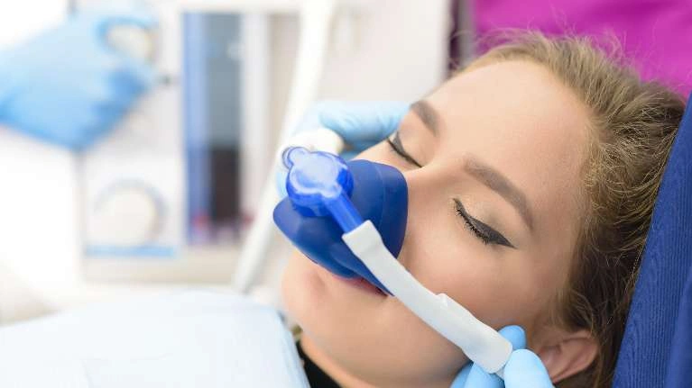 Dentist giving sedation to a patient