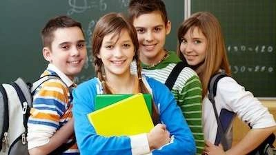 Four kids in school posing for a photo