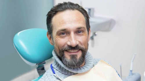 A patient smiling while visiting a dentist