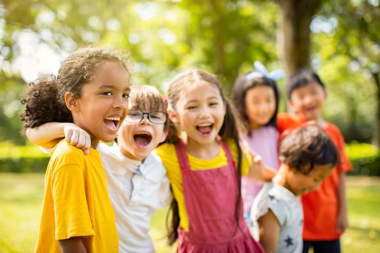 Six children smiling outdoors