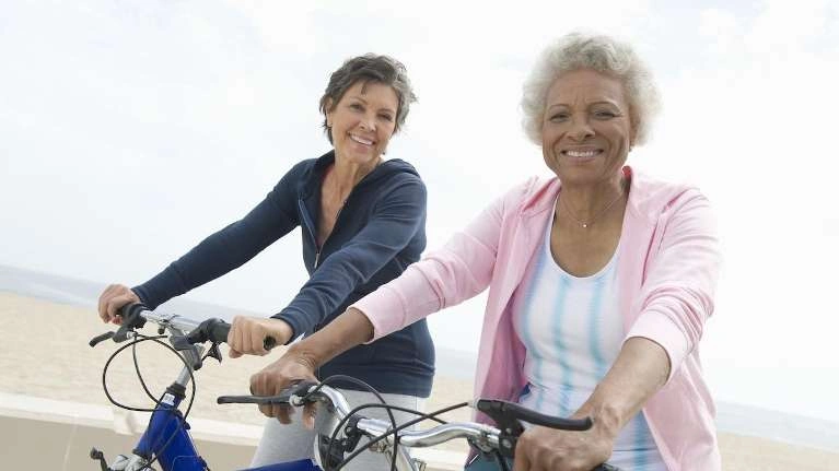 Two elderly woman riding bicycle