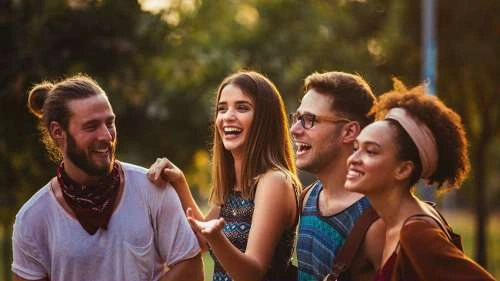 Four friends smiling outdoors