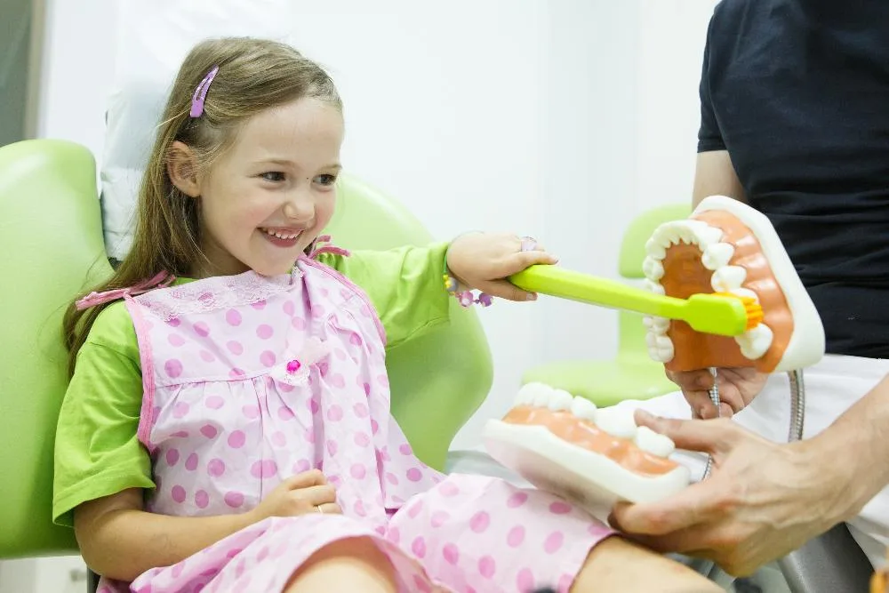 A child smiling and playing with a toy