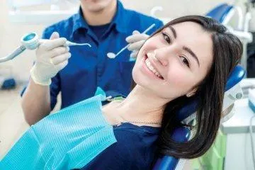 Woman smiling during a dental treatment