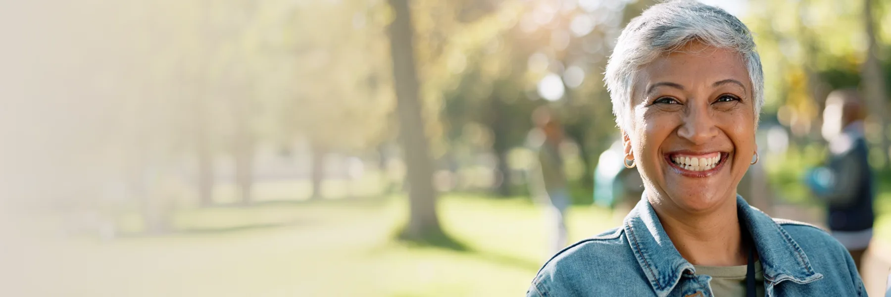 Woman smiling outdoors in a park