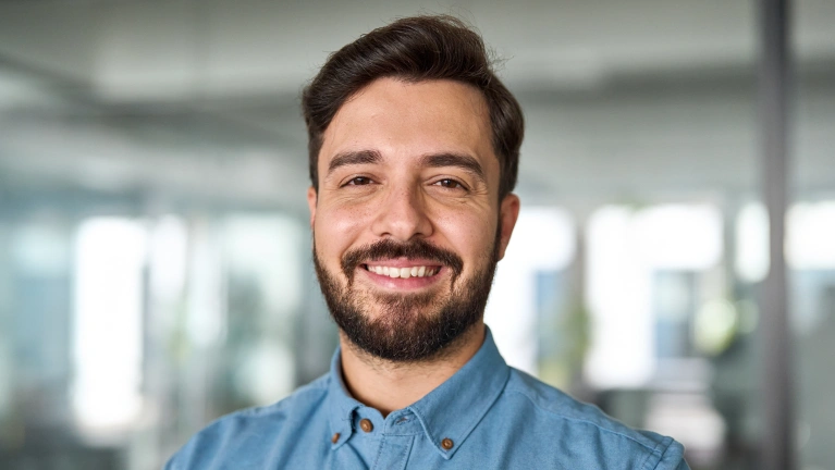 A man smiling in an indoor setting