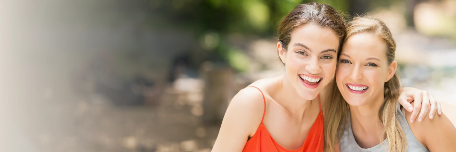 Two woman smiling outdoors