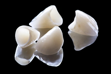 Dental crowns against a dark background