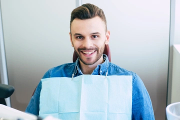 A man smiling in a dental chair