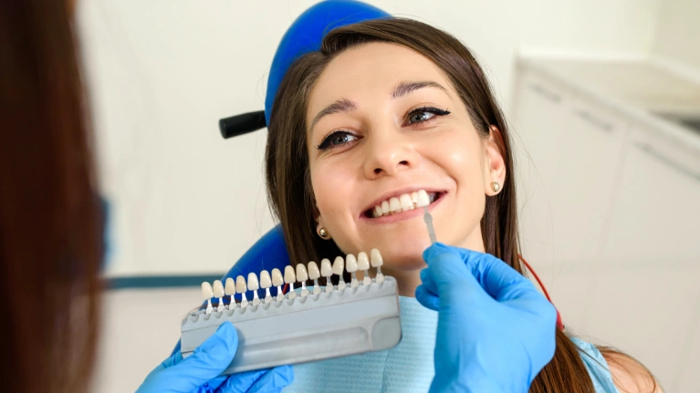A woman looking at dentist and smiling