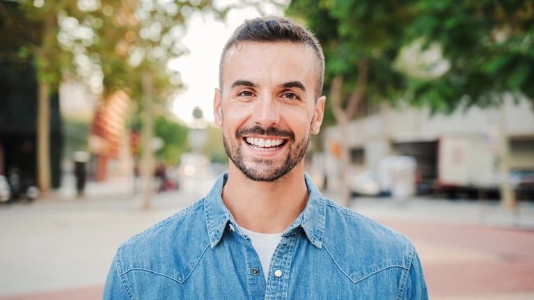 A man smiling outdoors